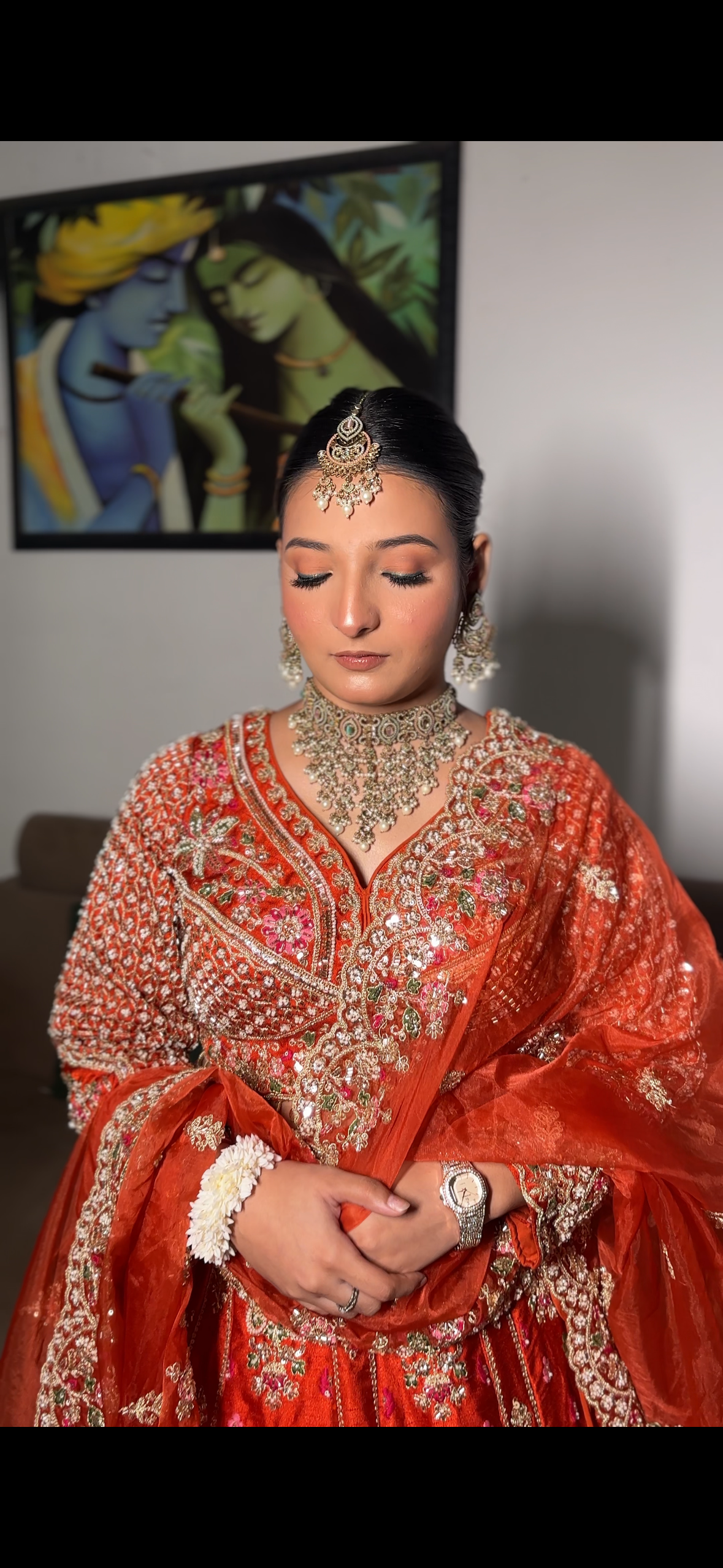 Bride in vibrant sunset orange and vermilion outfit for ring ceremony