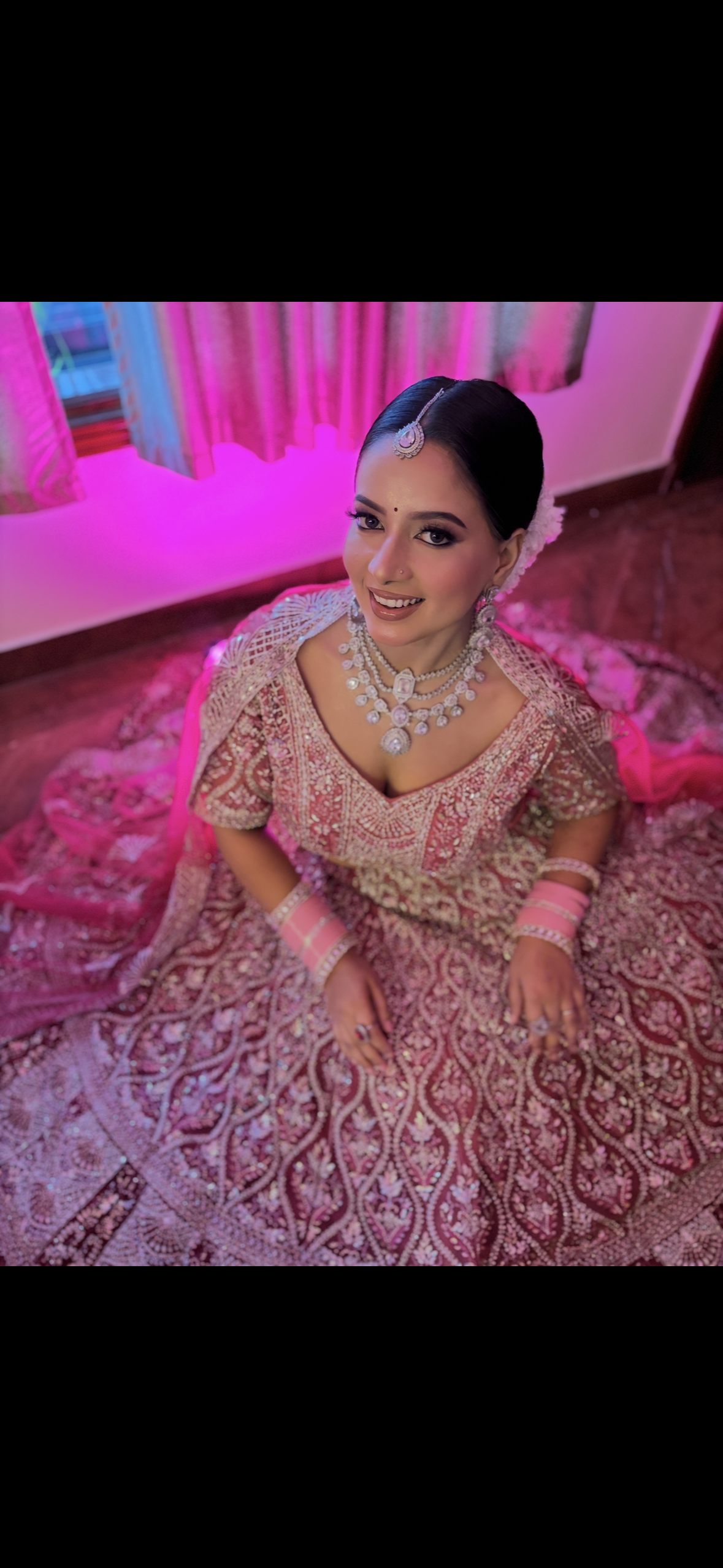 Bride in ethereal pastel silver and rose-gold lehenga with open wavy hairstyle